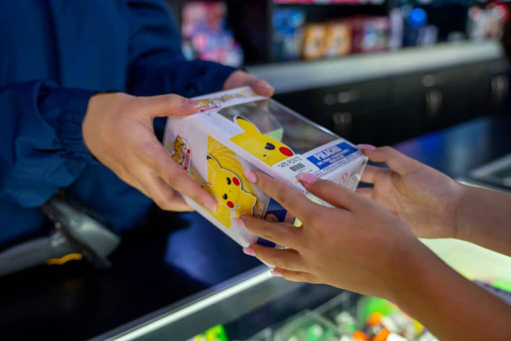 Girl receiving prize at arcade counter
