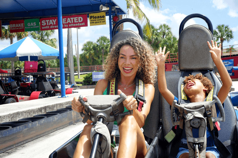 Woman and son ride go kart at Boomers Boca Raton