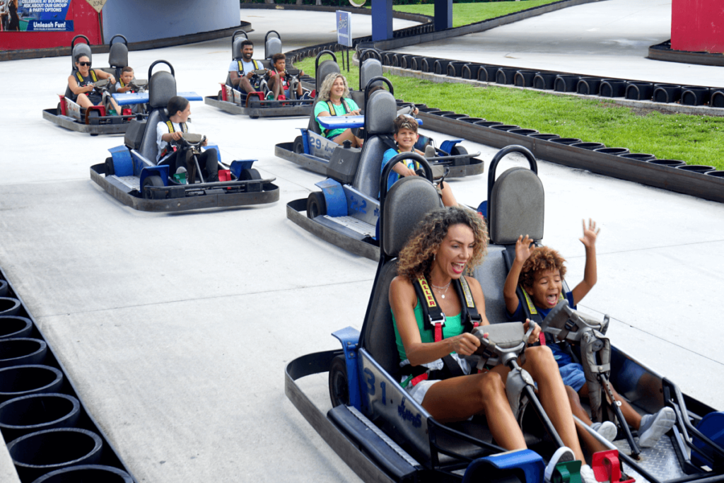 Group of friends ride go karts - Enjoy Unlimited Attractions Pass at Boomers