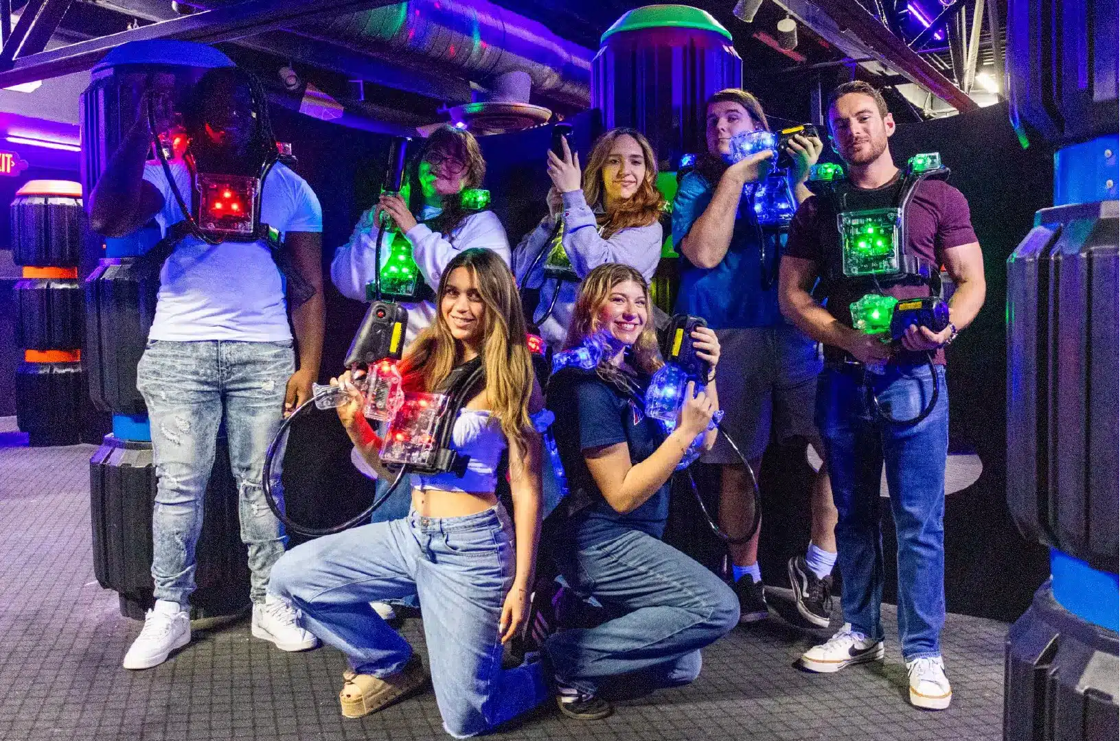 group of friends pose in laser tag gear at Boomers