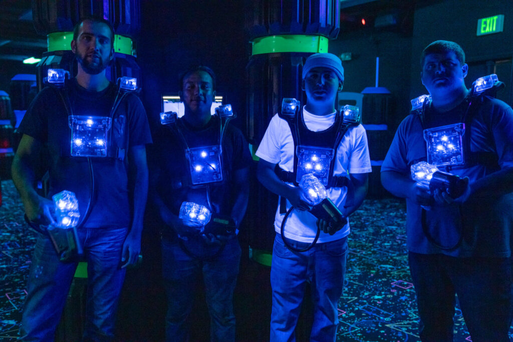 A group of teens in lighted lazer tag gear