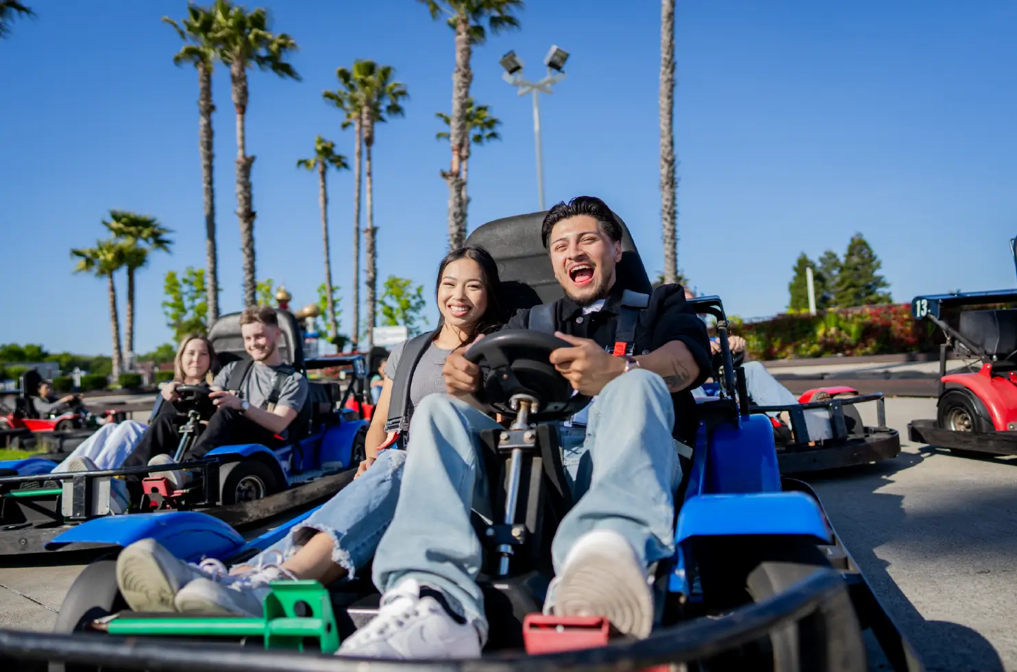 a couple drive a go kart on Boomers Livermore