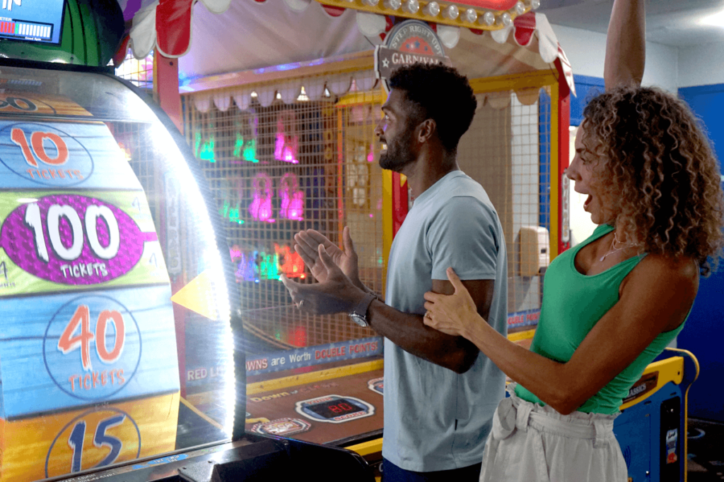 Couple play arcade game for tickets at Boomers Boca Raton