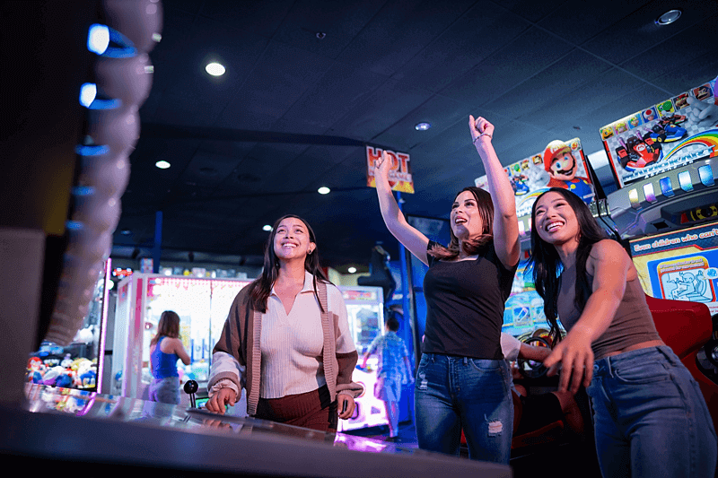 family play in arcade at Boomers