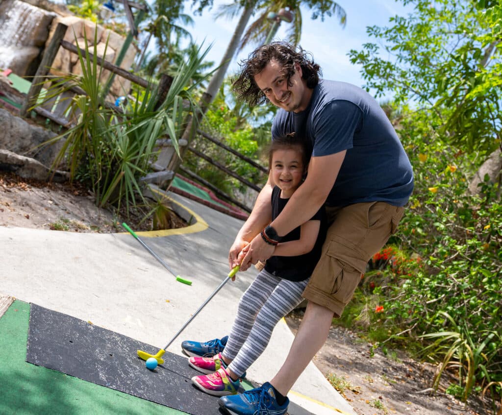 Father and daughter play Mini Golf at Boomers