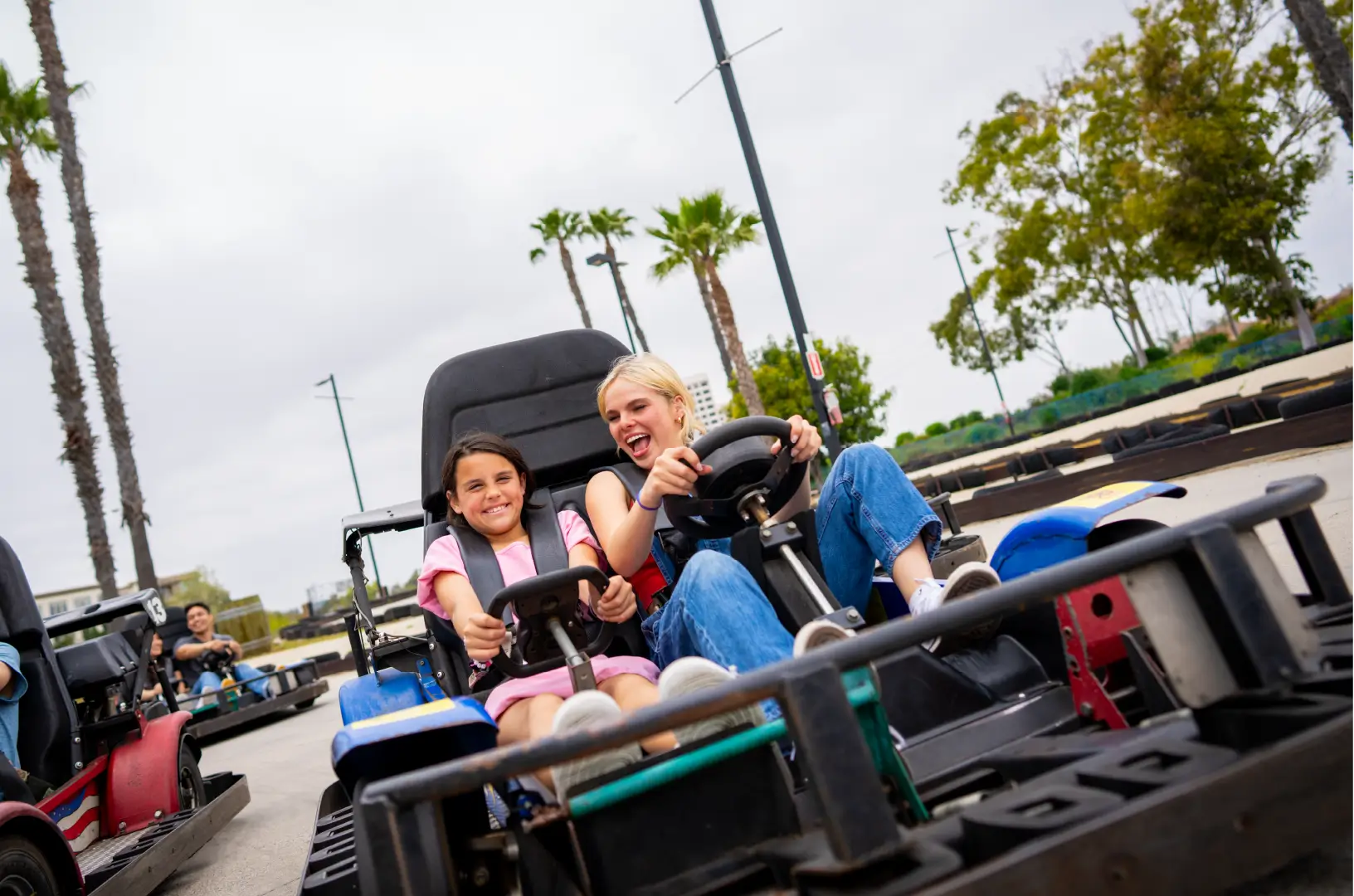 friends drive a go kart at boomers park