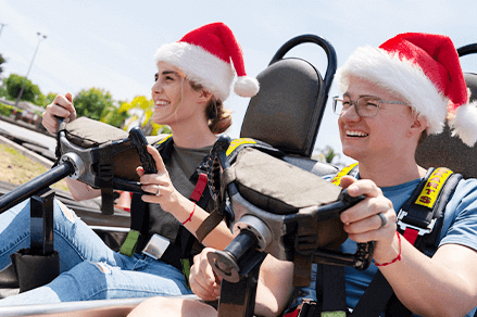 go kart riders in santa hats - Holiday Parties at Boomers