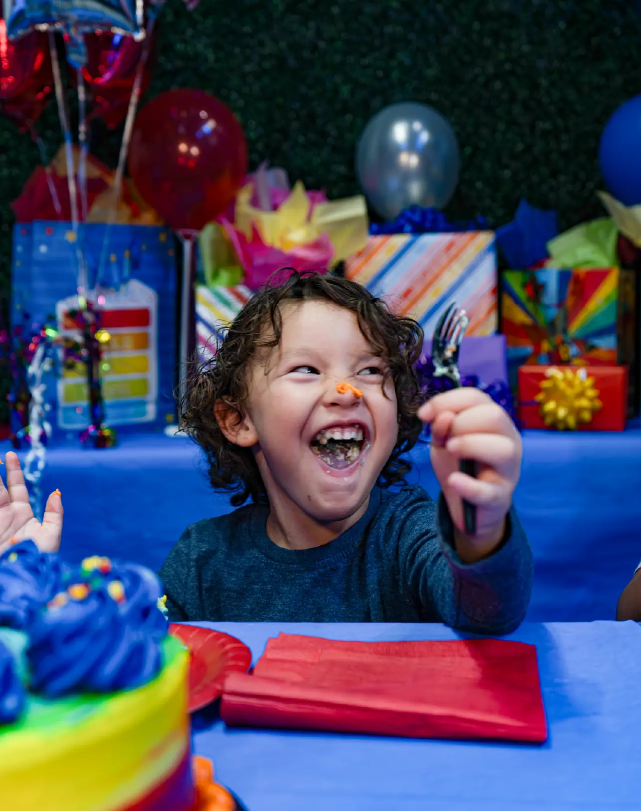 Happy kid eating cake at a Boomers birthday party