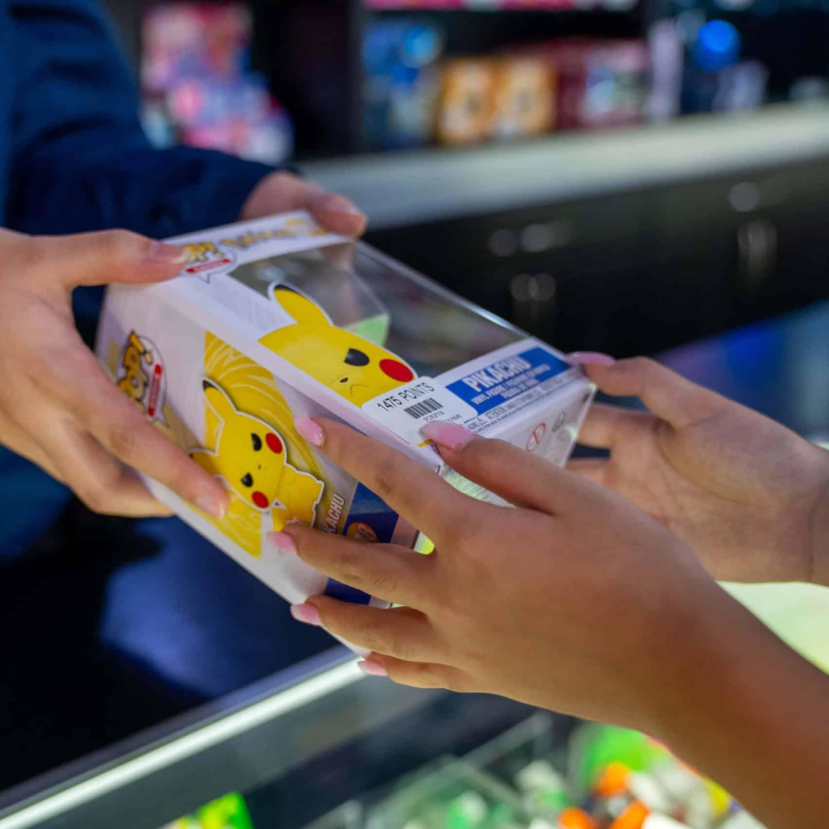 Arcade Prize Counter - child receiving toy from team member